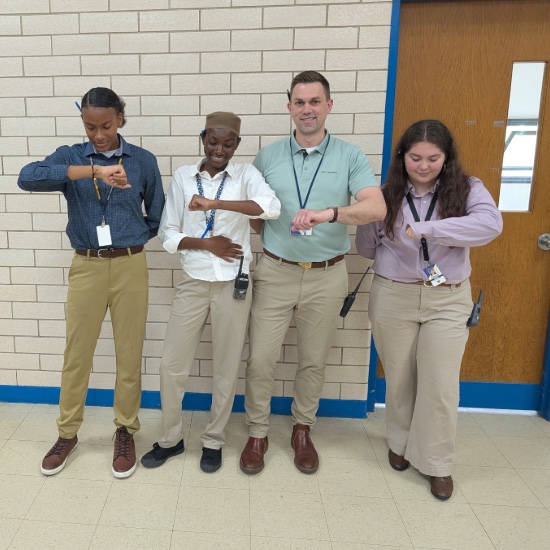  Milbourne with three students checking their watches